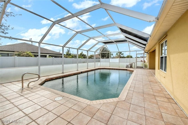 view of swimming pool featuring a lanai and a patio area