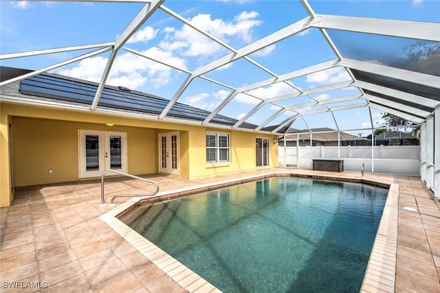 view of pool featuring french doors, glass enclosure, and a patio area