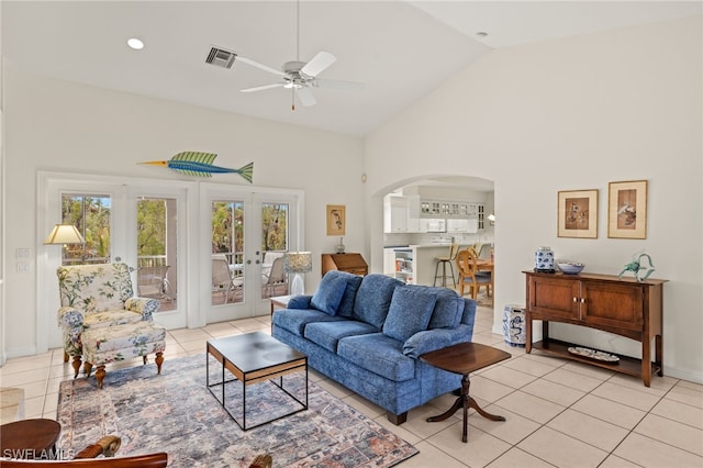 living room featuring french doors, high vaulted ceiling, ceiling fan, and light tile patterned floors