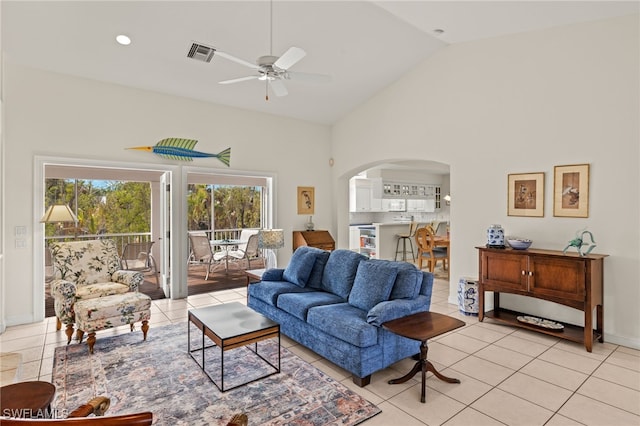 tiled living room featuring ceiling fan and lofted ceiling