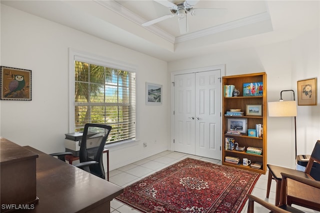 office featuring a raised ceiling, ceiling fan, light tile patterned floors, and ornamental molding