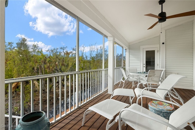 sunroom with lofted ceiling and ceiling fan