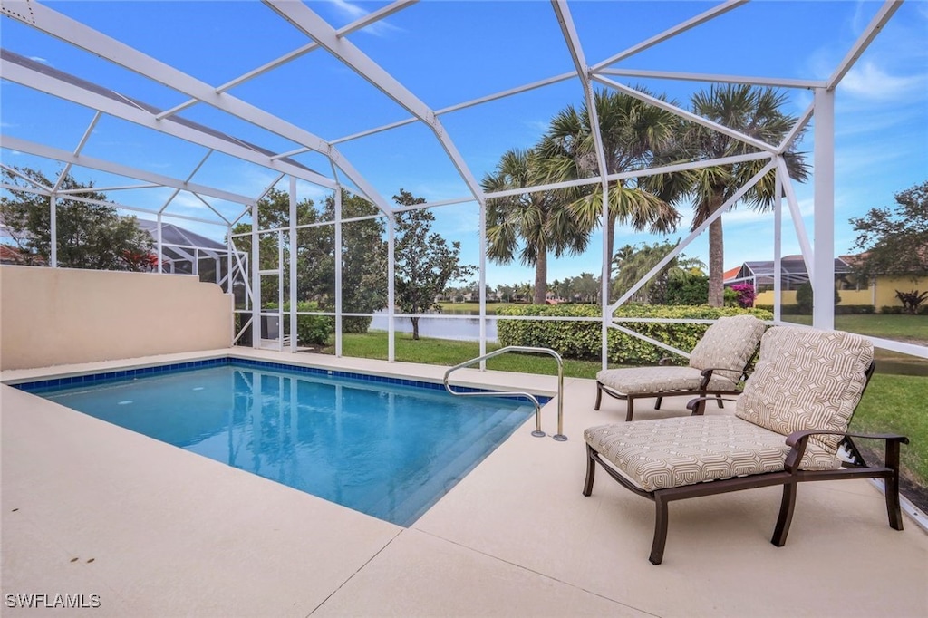 view of swimming pool featuring a lanai and a patio area