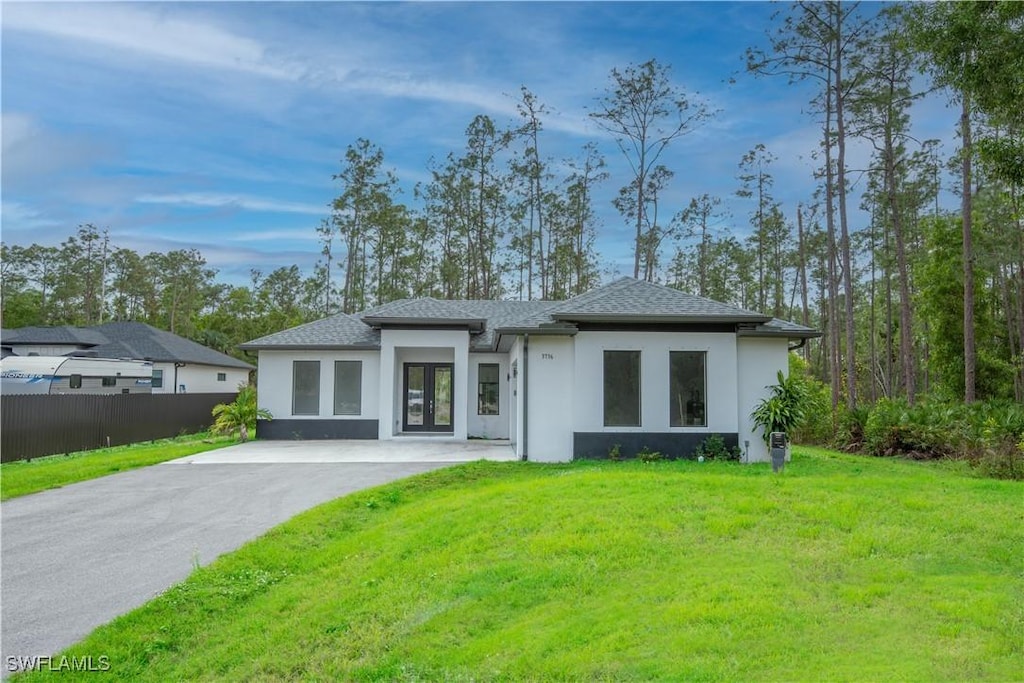 back of house featuring a lawn