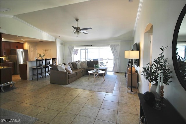 living room featuring ornamental molding, ceiling fan, lofted ceiling, and light tile patterned flooring