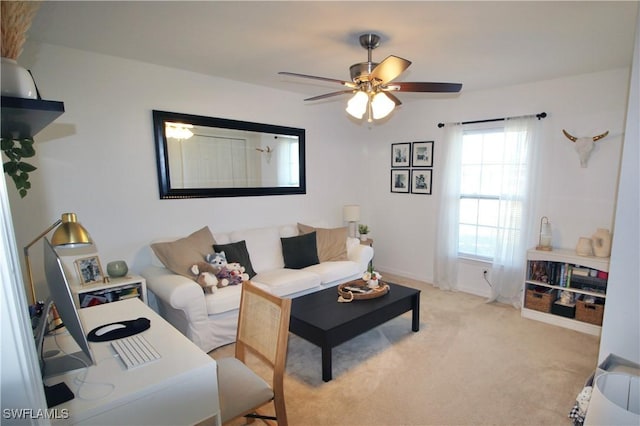 carpeted living room featuring plenty of natural light and ceiling fan