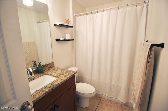 bathroom featuring toilet, vanity, and tile patterned floors