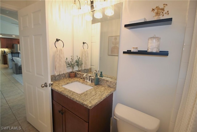 bathroom with tile patterned flooring, vanity, and toilet