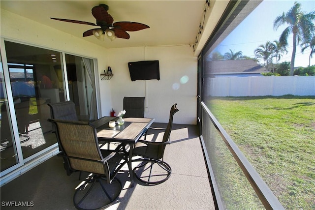 sunroom featuring ceiling fan