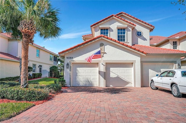 mediterranean / spanish home featuring a garage