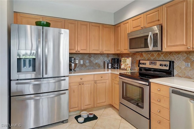 kitchen with stainless steel appliances, light tile patterned floors, tasteful backsplash, and light brown cabinets