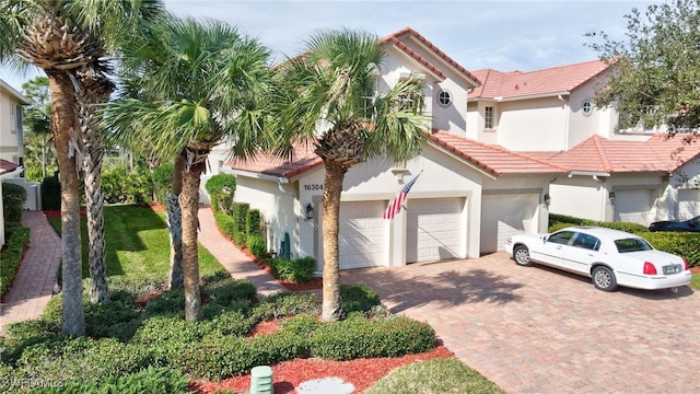 mediterranean / spanish-style home with a garage