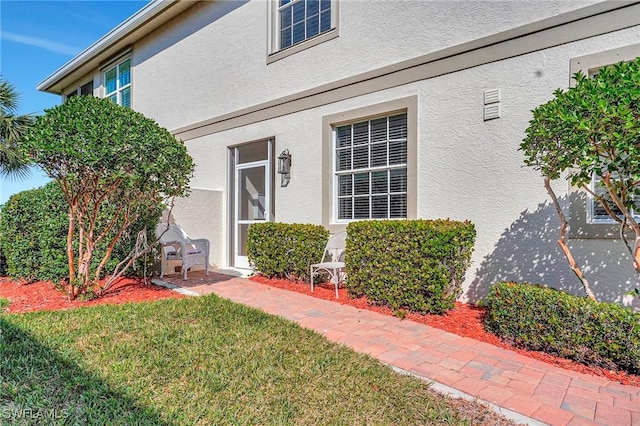 doorway to property featuring a yard