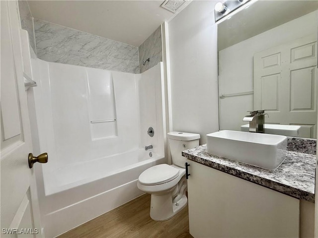 full bathroom featuring hardwood / wood-style floors, vanity, toilet, and shower / bathtub combination