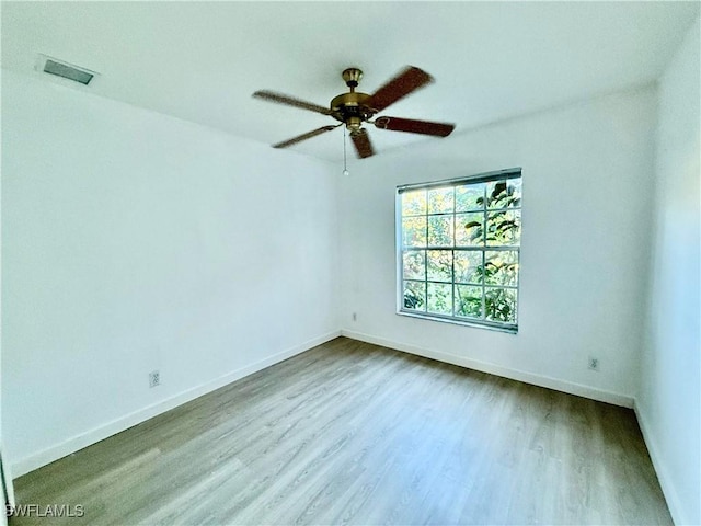 empty room featuring wood-type flooring and ceiling fan