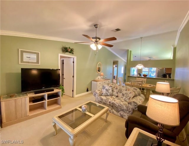 living room with lofted ceiling, light colored carpet, ornamental molding, and ceiling fan