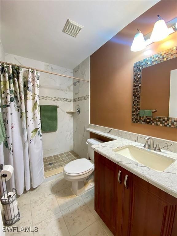 bathroom featuring vanity, toilet, and a shower with shower curtain