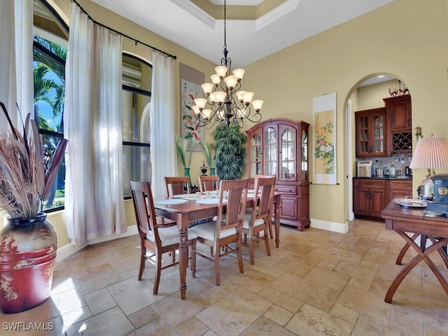 dining room with a raised ceiling and an inviting chandelier