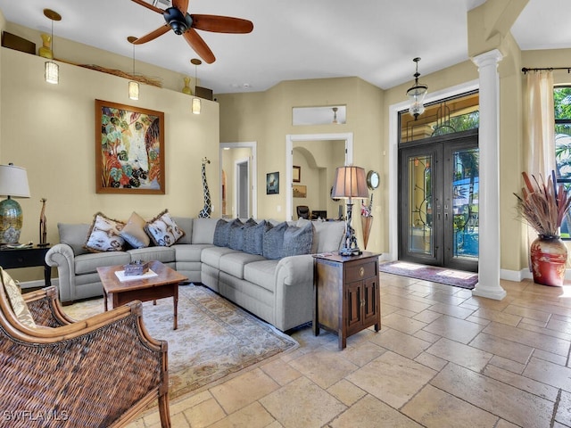 living room with ceiling fan and ornate columns