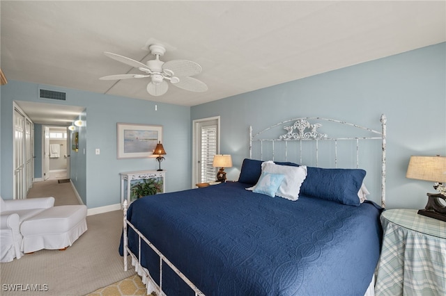 carpeted bedroom featuring ceiling fan and multiple windows