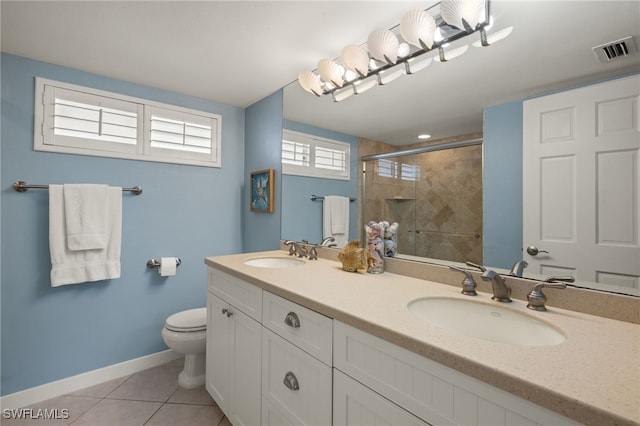 bathroom featuring an enclosed shower, vanity, tile patterned floors, and toilet