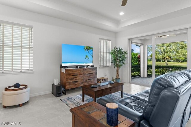 living room with ceiling fan and light tile patterned floors