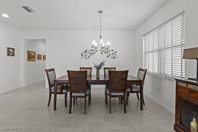 dining space with an inviting chandelier and light tile patterned floors