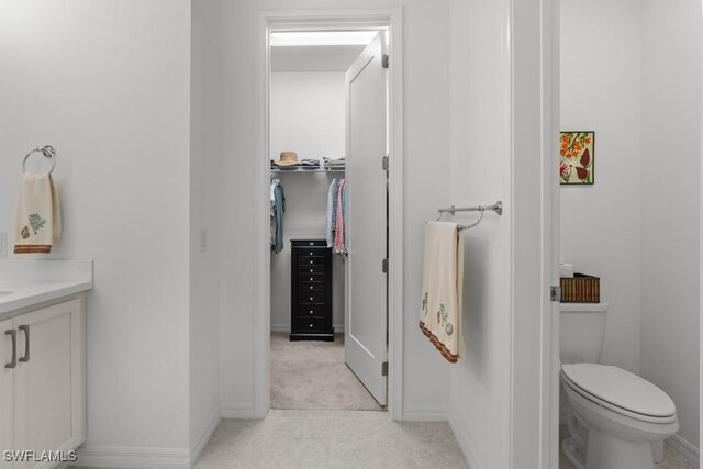 bathroom featuring toilet and vanity