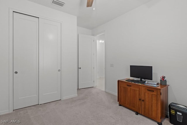 office space with ceiling fan and light colored carpet