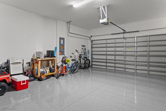 garage featuring a garage door opener and electric panel