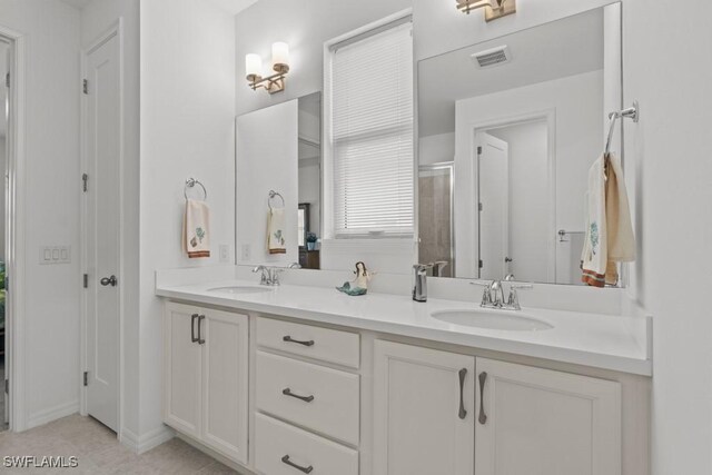 bathroom featuring vanity and a shower with door