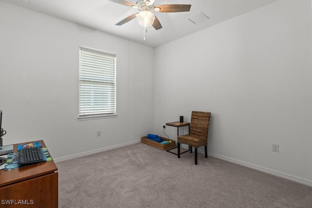 living area with light carpet and ceiling fan