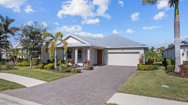 view of front of home with a front yard and a garage