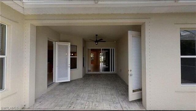 property entrance featuring ceiling fan and a patio area