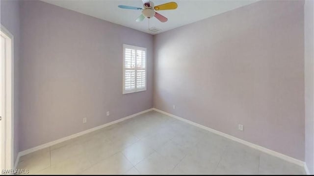 tiled spare room featuring ceiling fan