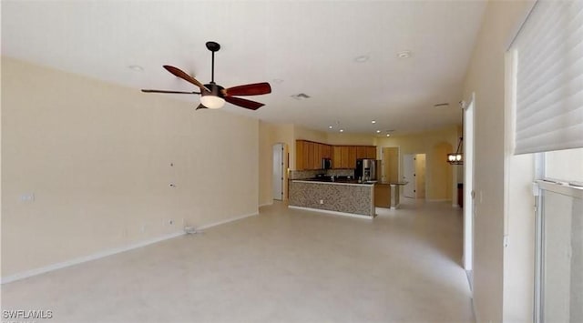 unfurnished living room featuring ceiling fan