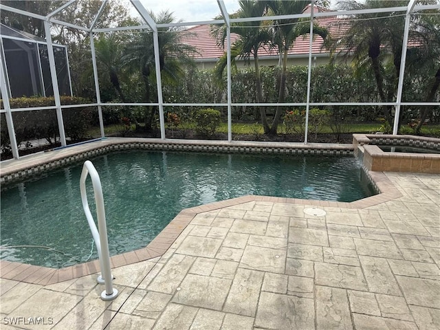 view of pool featuring a patio and glass enclosure