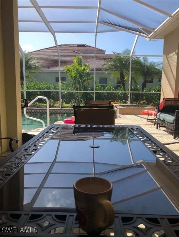 view of swimming pool with a patio and a lanai