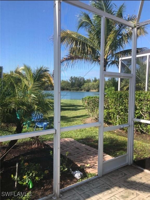 unfurnished sunroom with a water view and a wealth of natural light