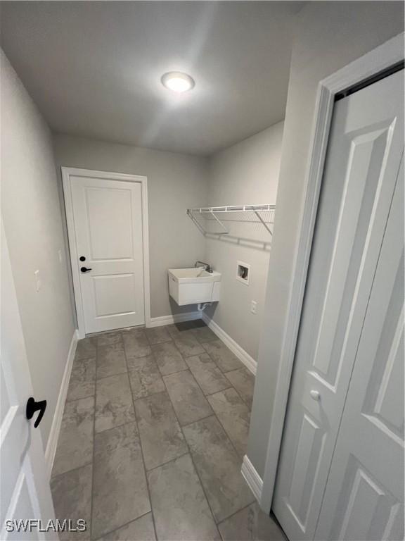 clothes washing area featuring sink and hookup for a washing machine