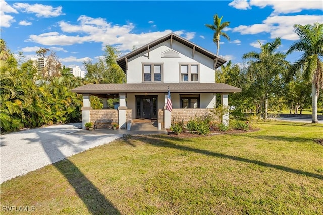 view of front of house with covered porch and a front yard