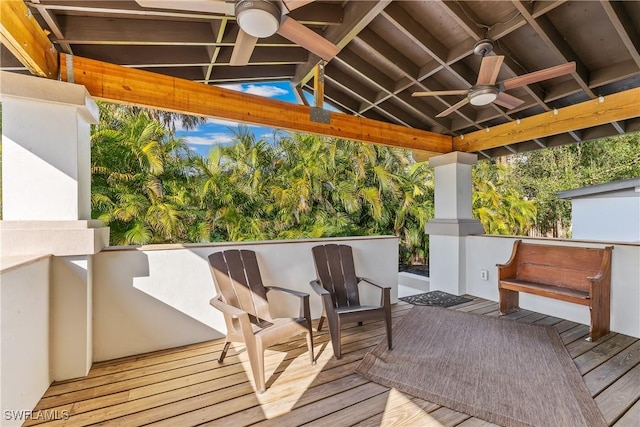 wooden terrace featuring ceiling fan and exterior bar