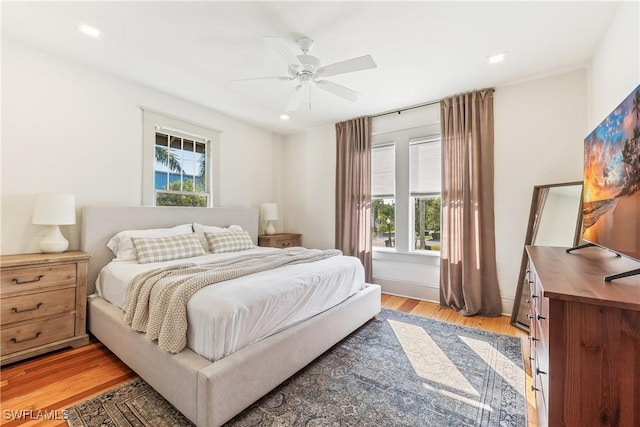 bedroom with light wood-type flooring and ceiling fan