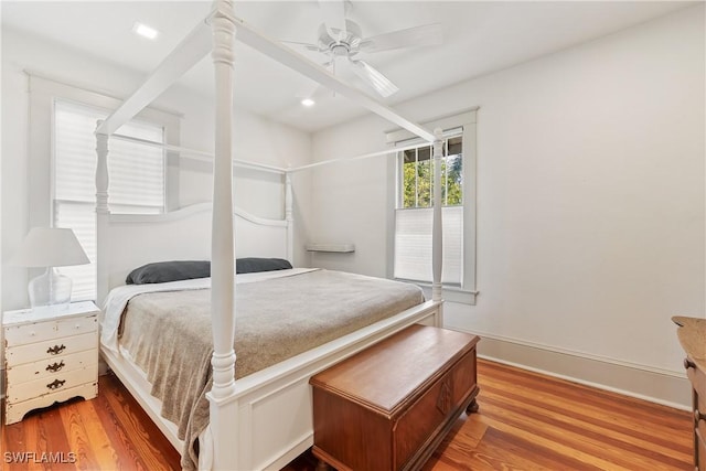 bedroom with ceiling fan and light wood-type flooring