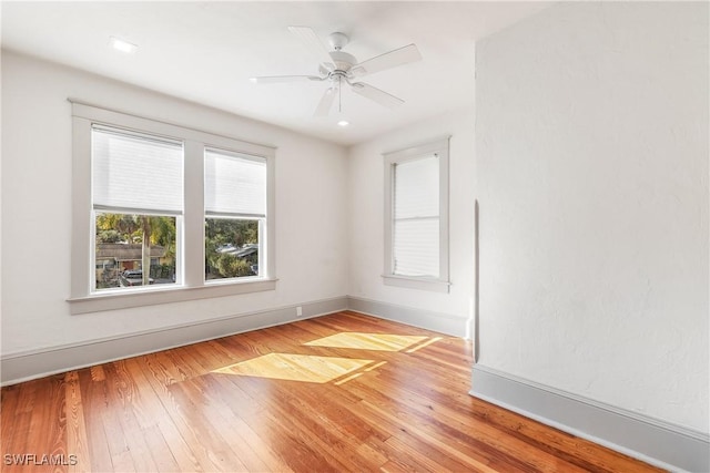 spare room featuring light hardwood / wood-style flooring and ceiling fan