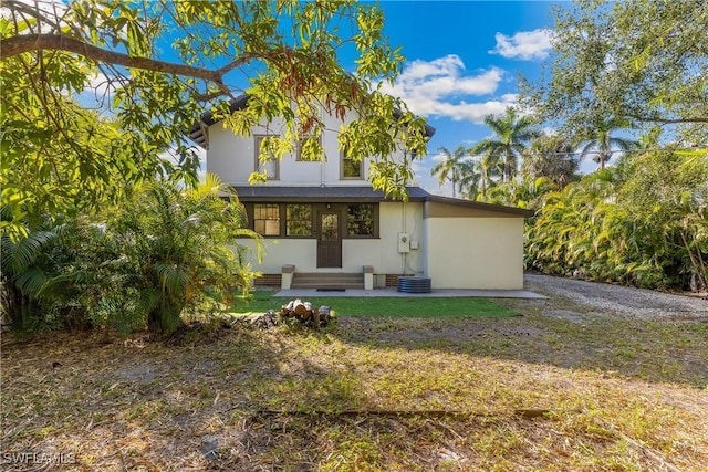 rear view of house with a yard