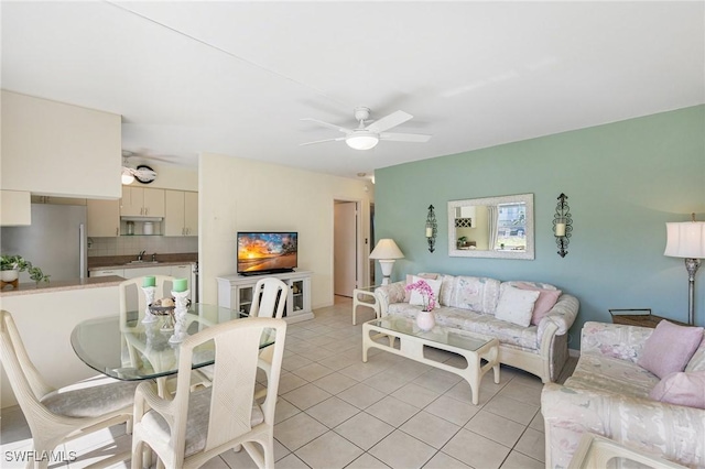 tiled living room featuring ceiling fan and sink