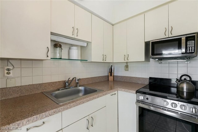 kitchen featuring white cabinetry, decorative backsplash, sink, and stainless steel appliances