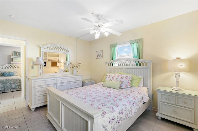 tiled bedroom featuring ceiling fan