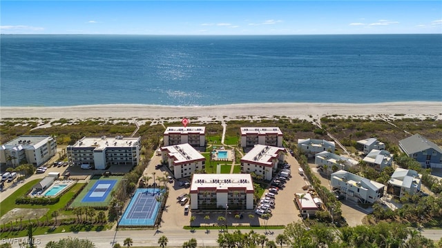 drone / aerial view with a water view and a view of the beach